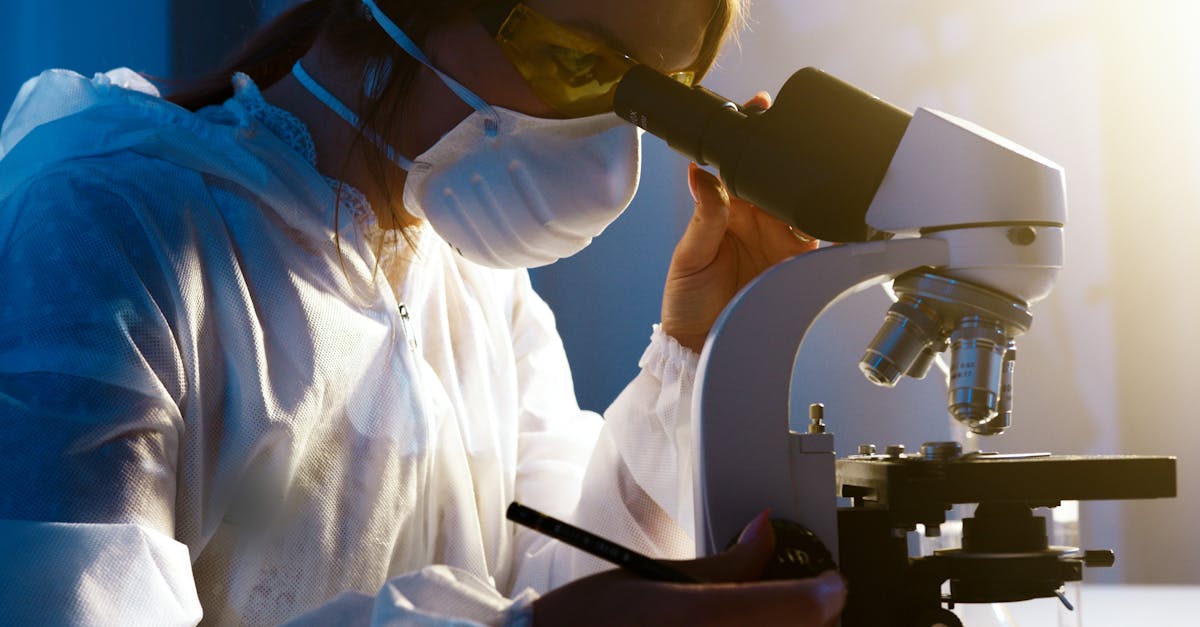 Doctor in a white coat writing medical content on a laptop for digital marketing.