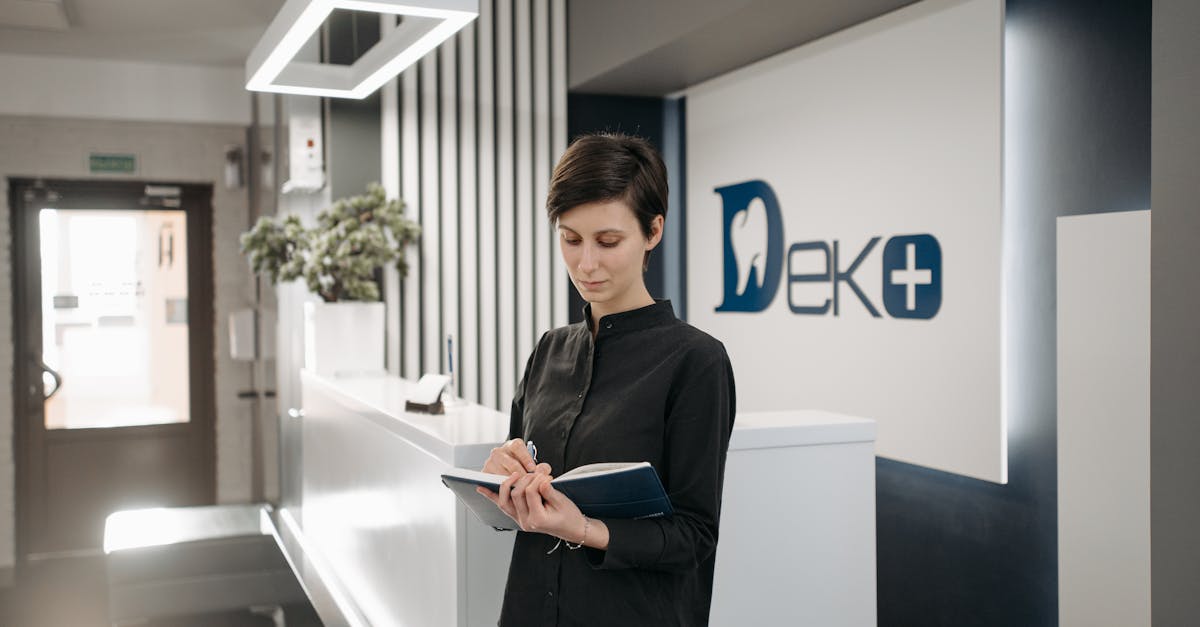 Modern clinic reception with a tablet showing the Tadawi patient scheduling interface.