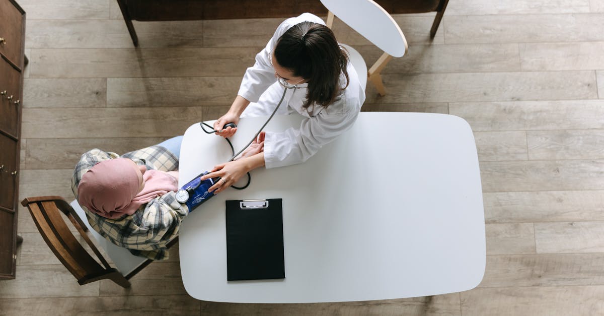 Clinic receptionist using a tablet for patient appointment scheduling.
