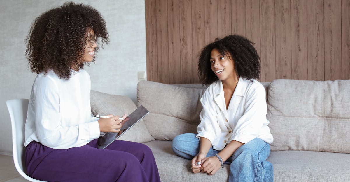A smiling patient uses a tablet to schedule their next therapy session in a bright, modern clinic waiting room.