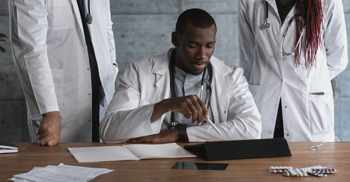 Team of doctors and nurses collaborating over a computer with electronic health records.