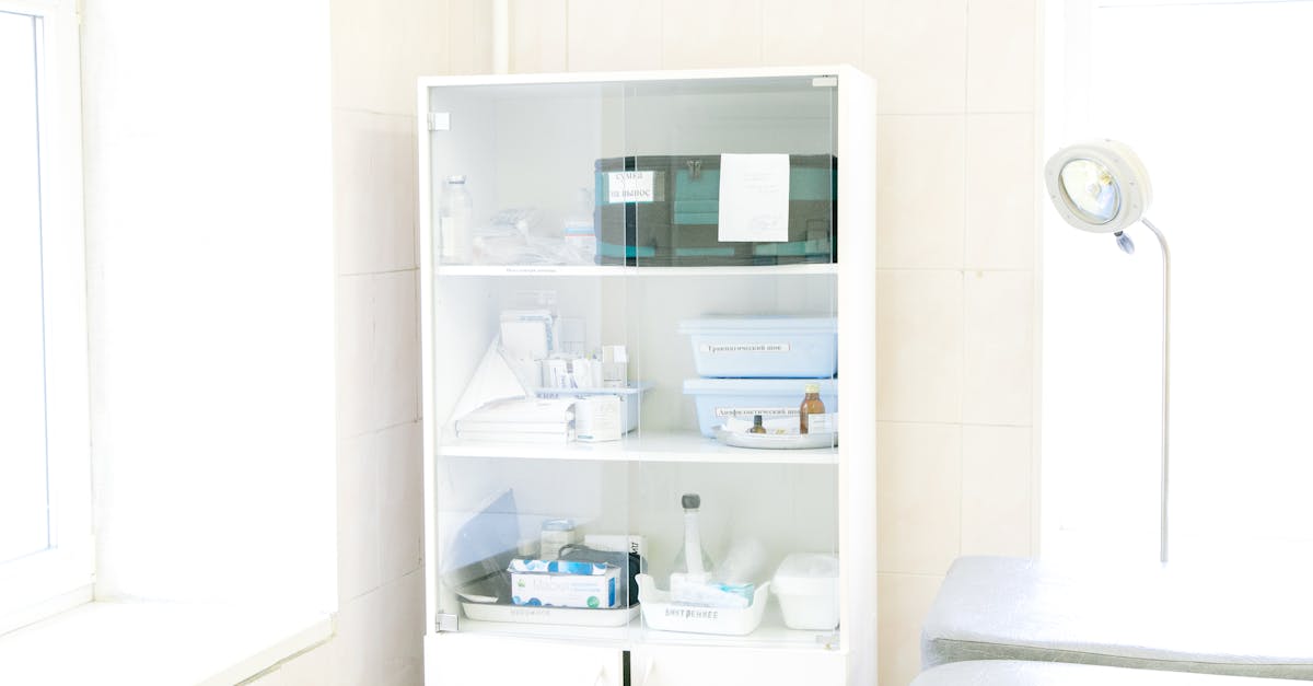A neatly organized shelf in a clinic's storage room with labeled boxes of medical supplies.