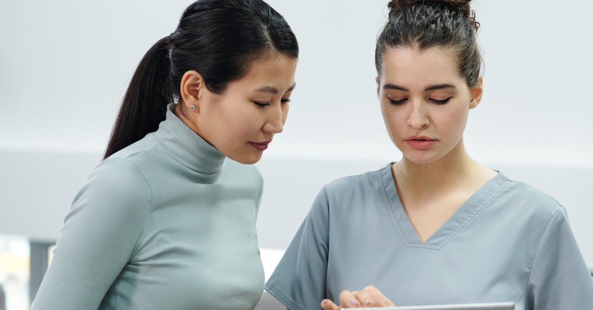 A diverse team of medical professionals collaborating in a meeting room, viewing data on a digital screen.