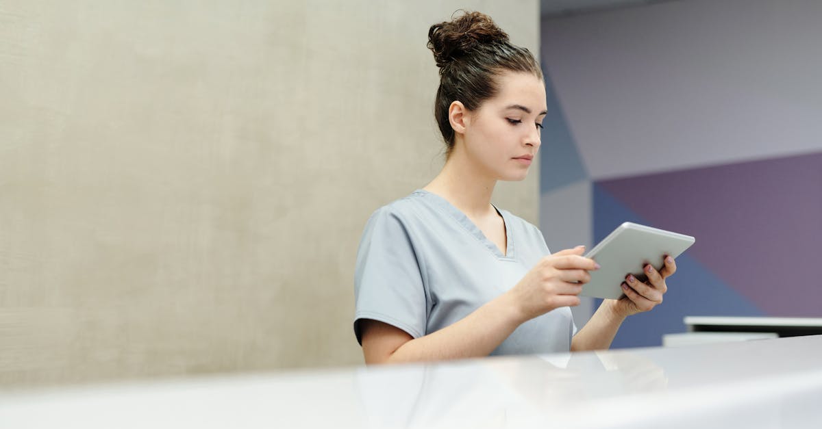 A female doctor in a white coat analyzing patient data graphs on a large digital screen in a modern, well-lit clinic office.