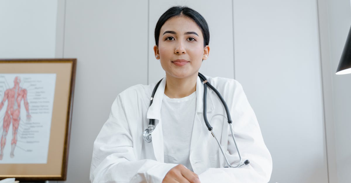 Patient using a smartphone to book a medical appointment online through a clinic's patient portal app.