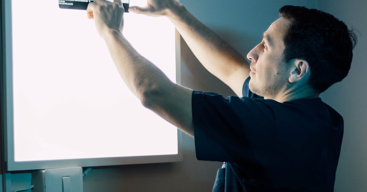 Healthcare professional using a tablet with clinic management software to schedule a patient's mammogram appointment.