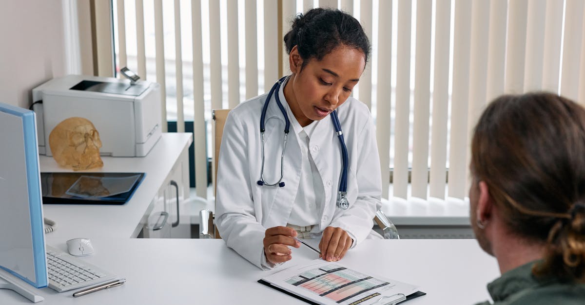 Clinic receptionist efficiently managing patient appointments on a computer using a management system.